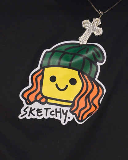 Person wearing a black t-shirt with a cartoon character and 'Sketchy' text design.